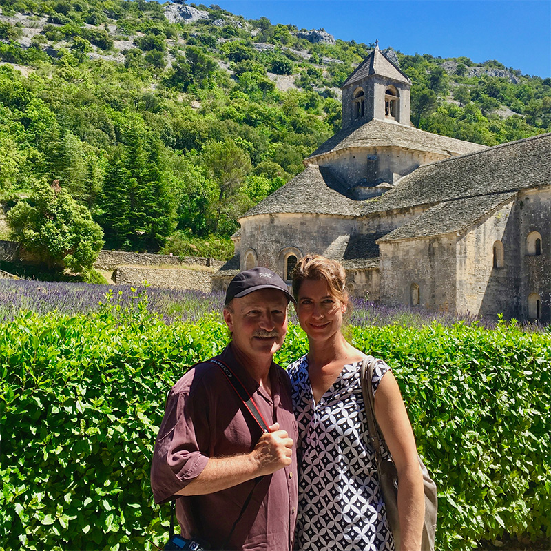 La Chouette Owners, Ben and Michelle in front of a European castle